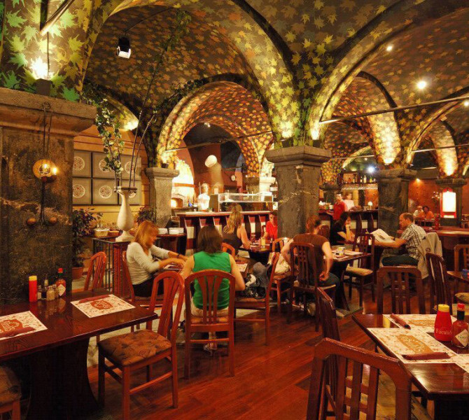 The interior of a restaurant with wooden furniture.
